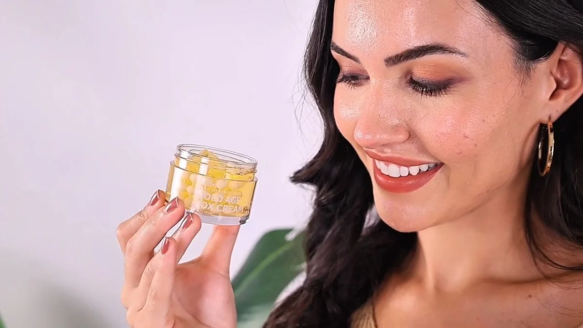 Indian woman creator holding a gold capsule skincare jar close to the camera, soft natural light, texture-focused UGC frame used to plan creative diversity UGC ads
