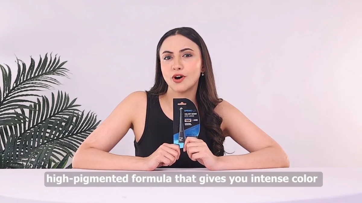 Indian beauty creator presenting an eyeliner to camera with a burned-in caption bar, showing how caption placement affects Reels ad caption overlap